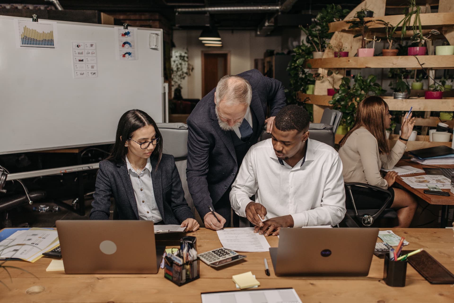 A leadership team reviewing documents together at a shared desk